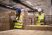 warehouse-workers-using-bar-code-scanner-tablet-checking-goods-inventory